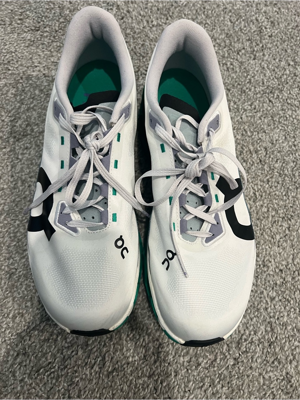 On Cloudmonster Running White Athletic Shoes with Black and Teal Accents